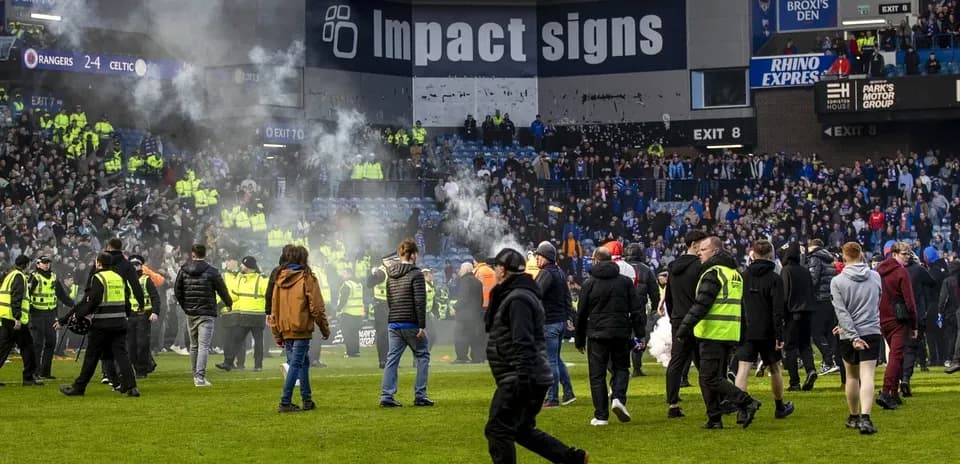 Fans and security on pitch after match disturbance