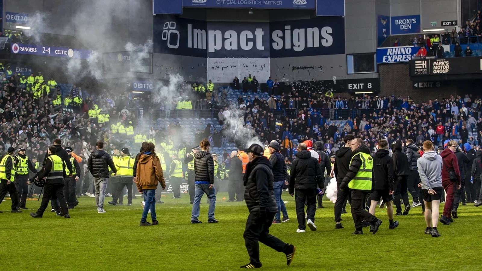 Fans and security on pitch after match disturbance