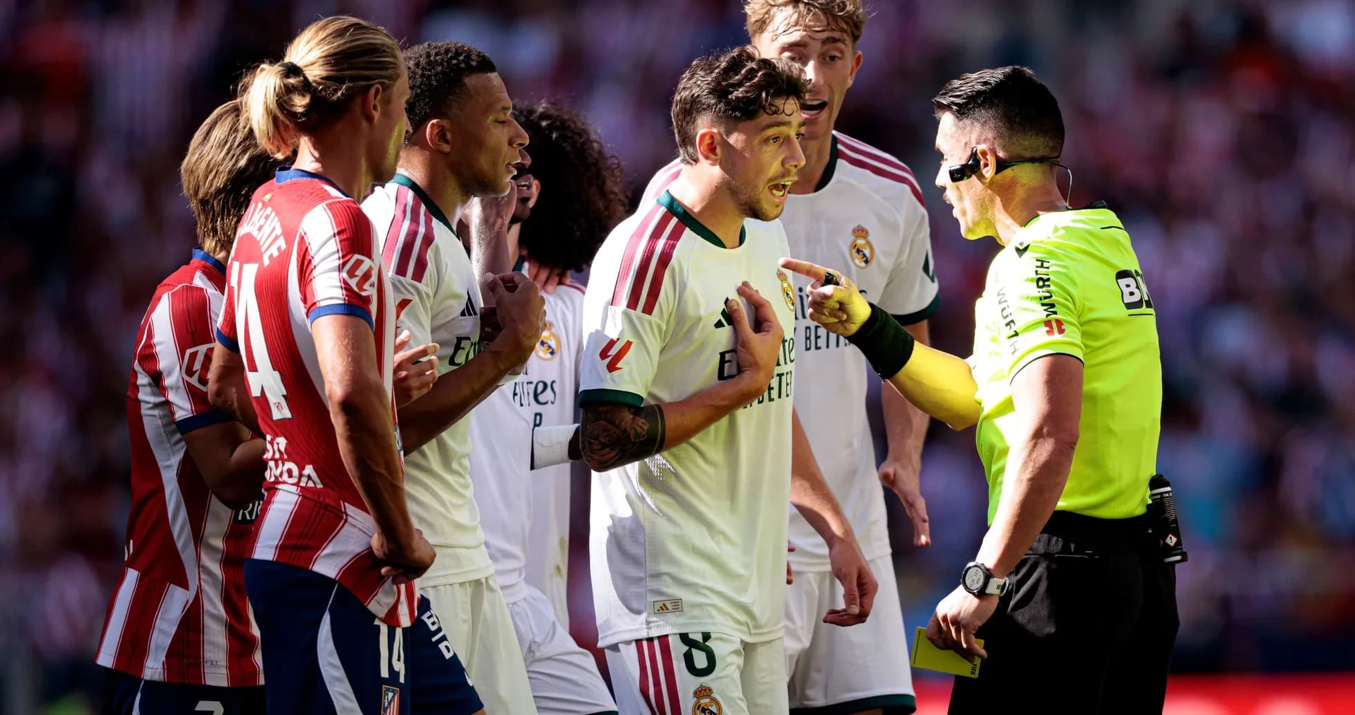 Real Madrid players arguing with referee during match