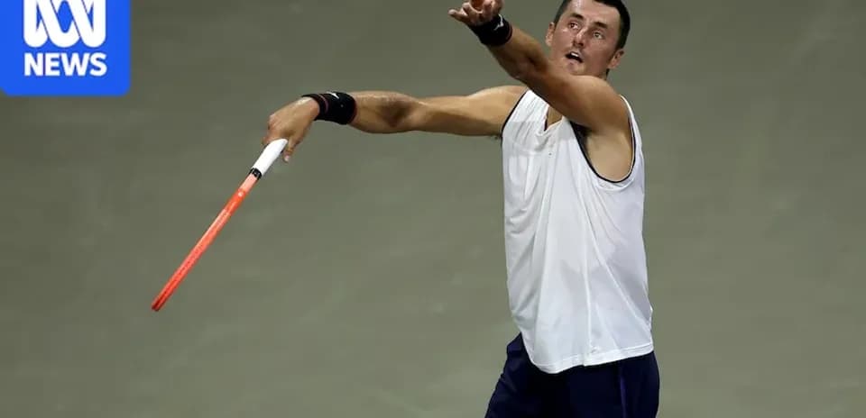 Tennis player serving during a match