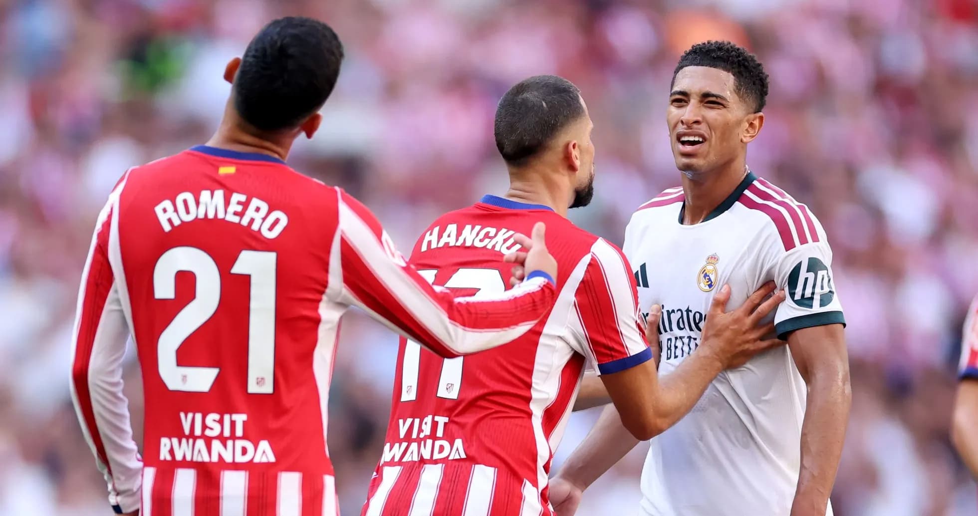 Atletico players confronting Real Madrid player during match
