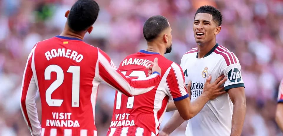 Atletico players confronting Real Madrid player during match