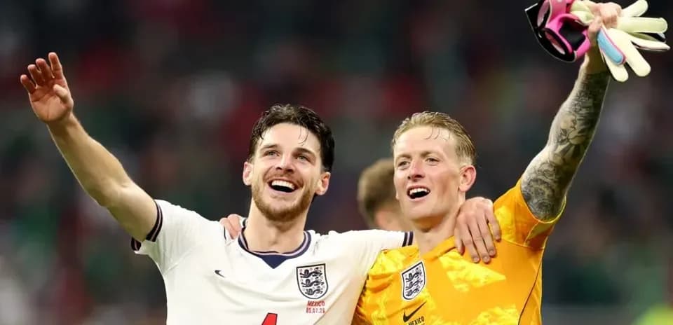 Two England players celebrating after a match
