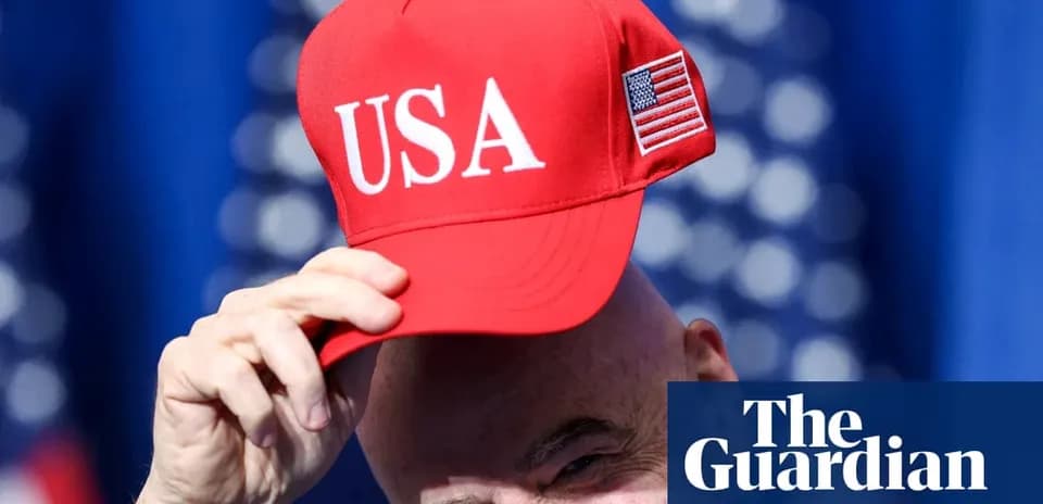 Shirtless man wearing red USA cap at event