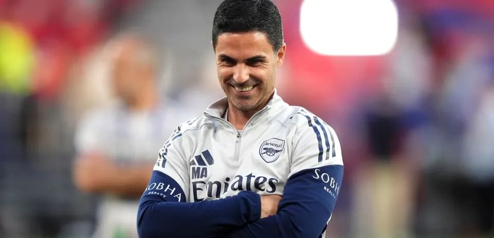 Arsenal manager smiling during match preparations
