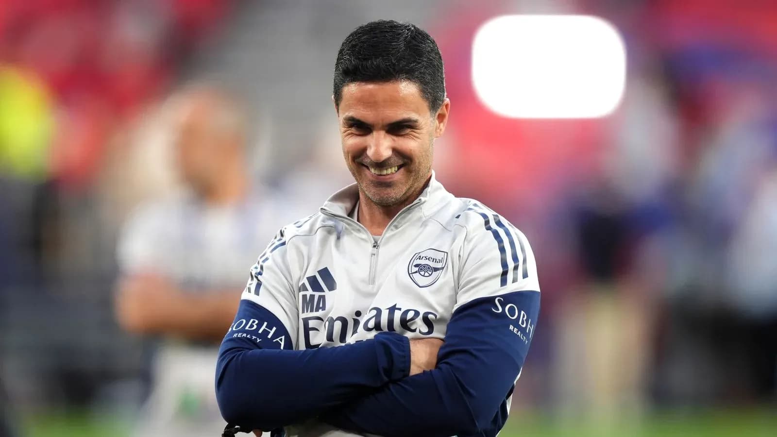 Arsenal manager smiling during match preparations