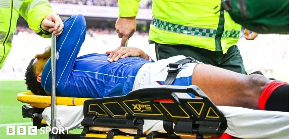 Player being assisted on stretcher by paramedics