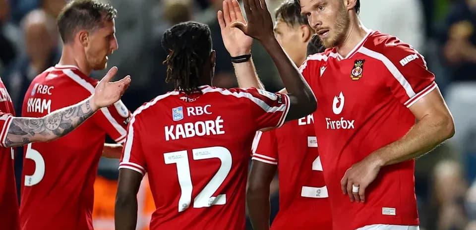 Football players celebrating a goal in red jerseys