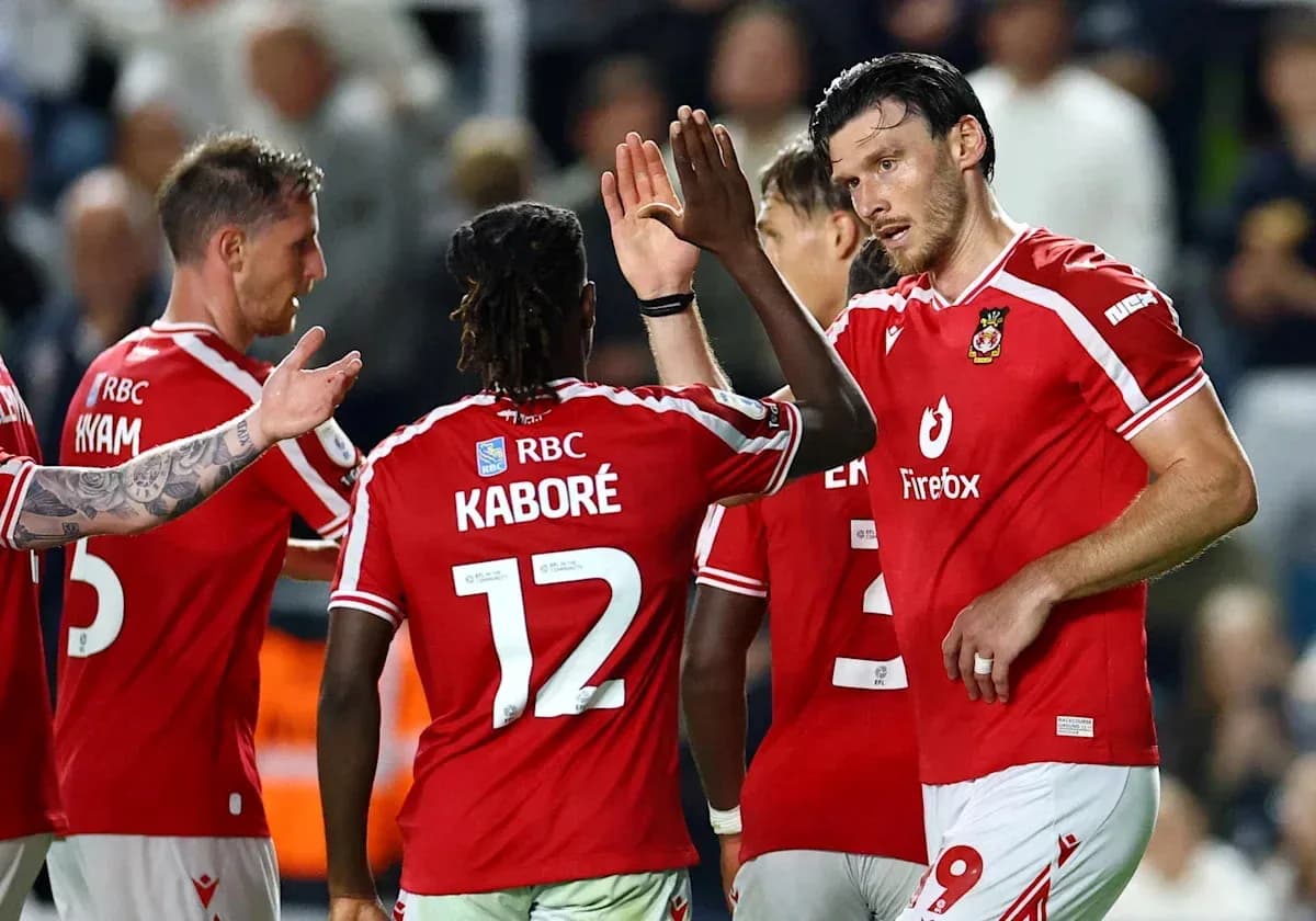 Football players celebrating a goal in red jerseys