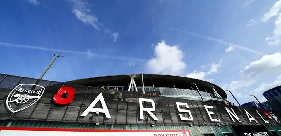 Arsenal Stadium exterior with logo and poppy