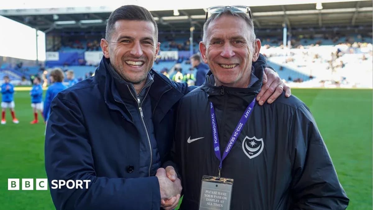 Two men shaking hands on football pitch
