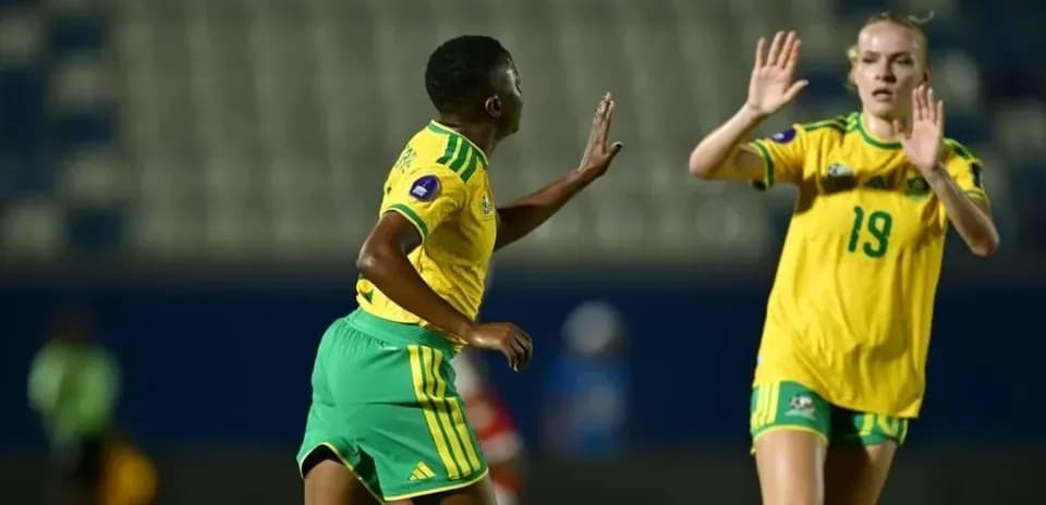 Two female football players during match action