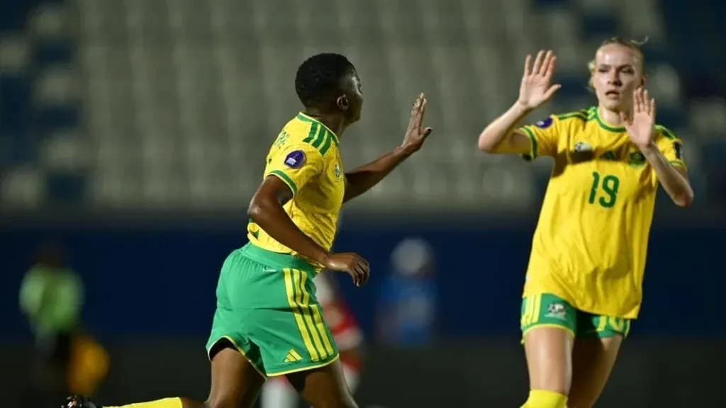 Two female football players during match action