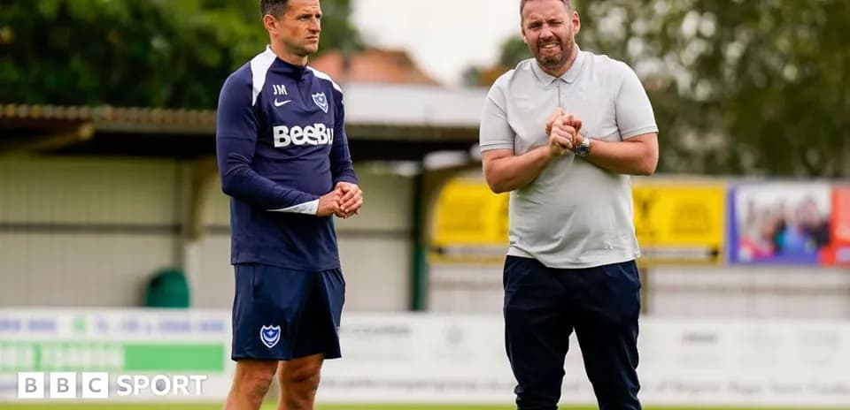 Two coaches discussing on the training ground