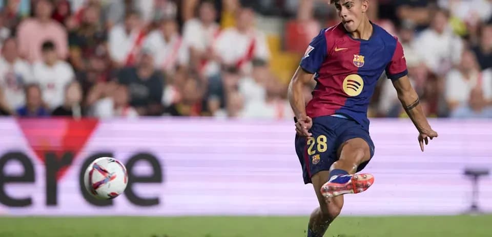 Barcelona player kicking the ball during match