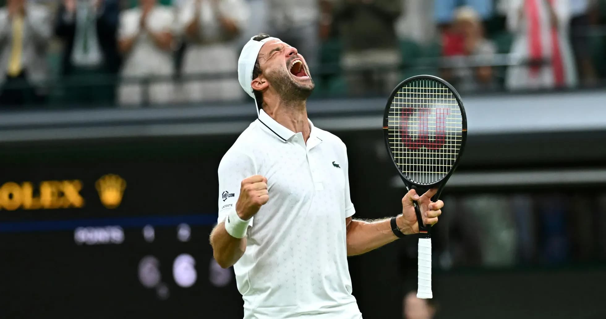 Tennis player celebrating victory at Wimbledon