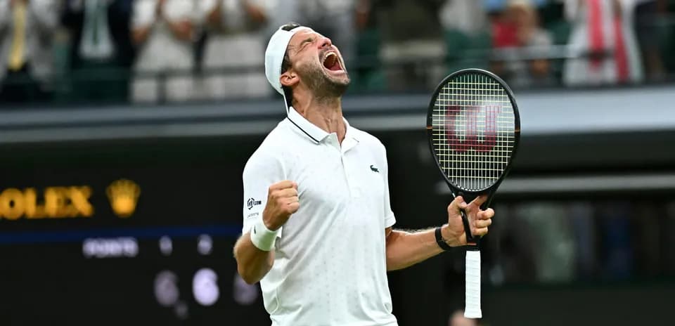 Tennis player celebrating victory at Wimbledon