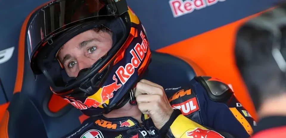 Motosport rider adjusting helmet before race