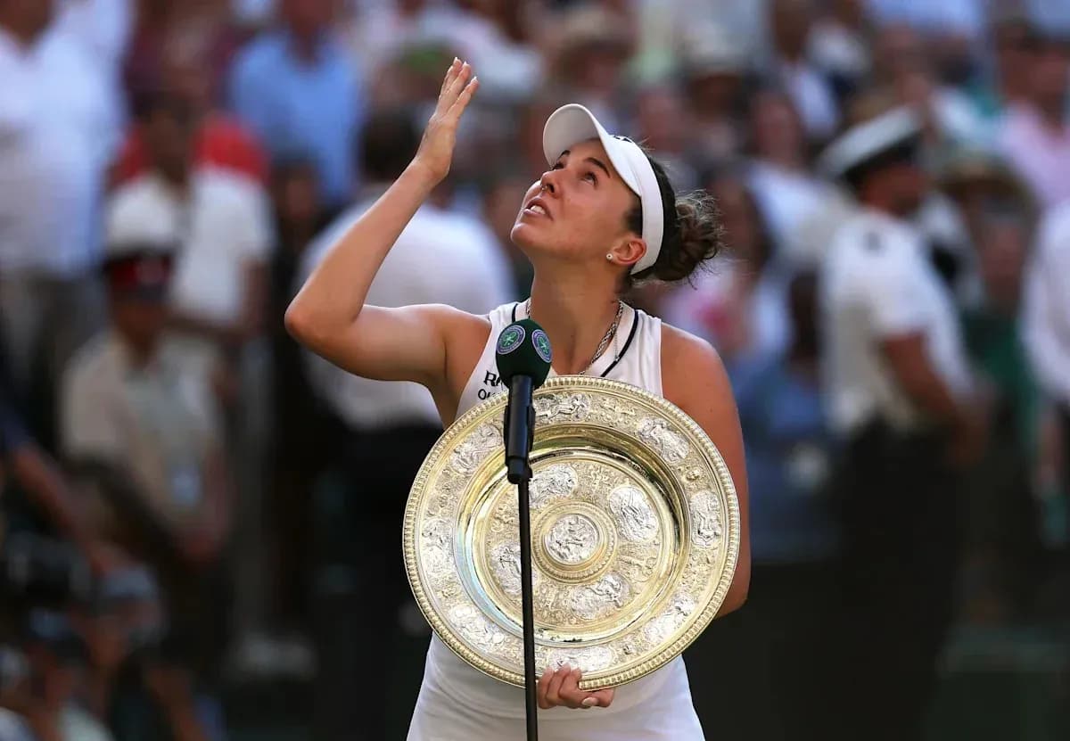 Tennis player holding trophy and looking up