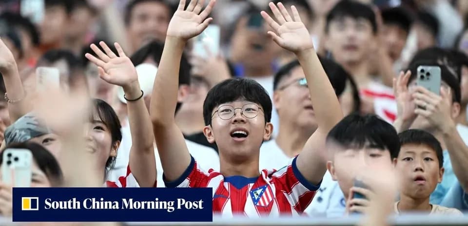 Young fan in Atlético Madrid jersey cheering in crowd