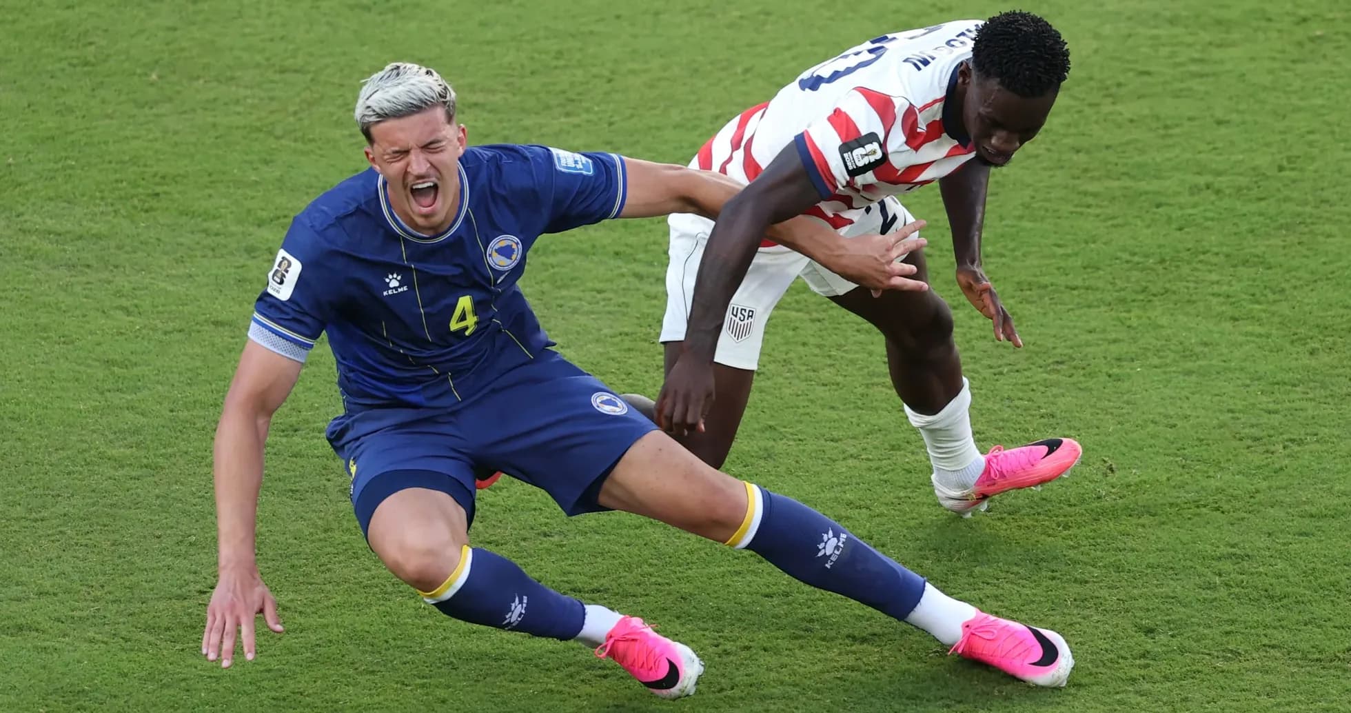 Bosnia player falls while USA player competes for ball