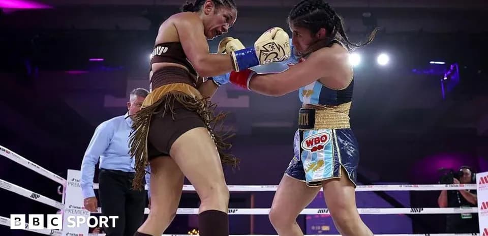 Two female boxers competing in the ring