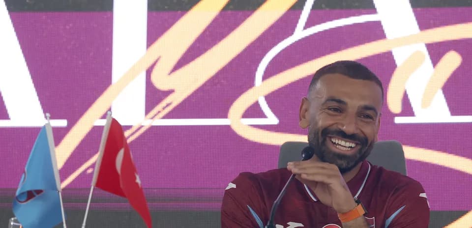 Futbolchi matbuot anjumanida kulayotgan