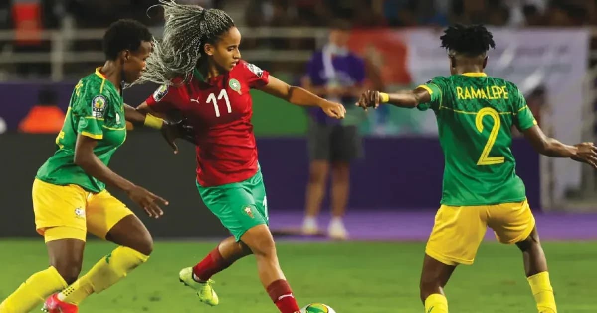 Moroccan player dribbling past two defenders during match