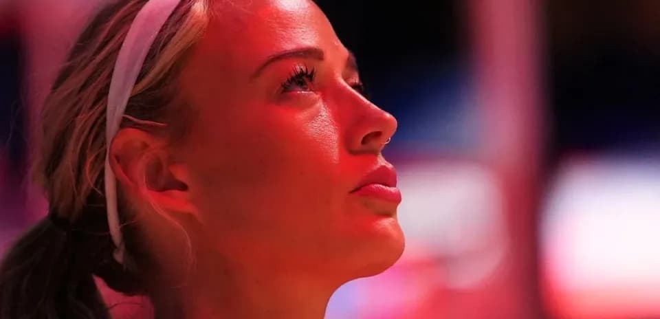 Basketball player looking up in arena lights