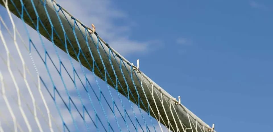 Close-up of a sports goal net against sky