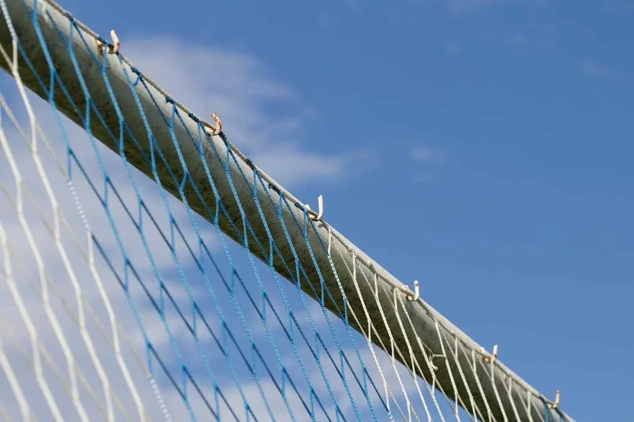 Close-up of a sports goal net against sky