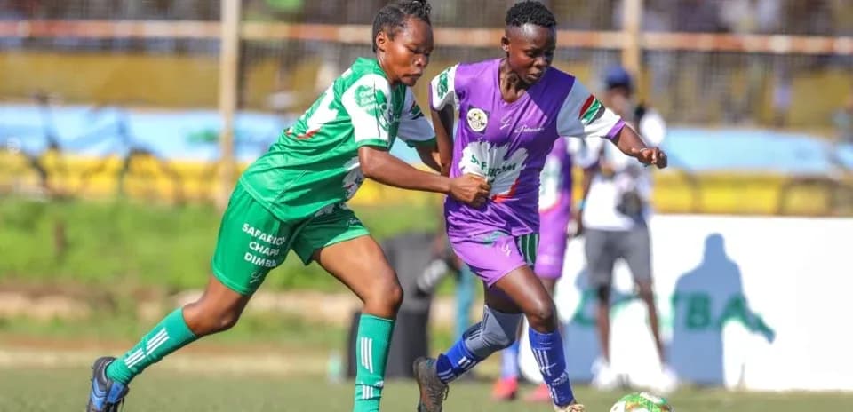 Two players competing for the ball on field