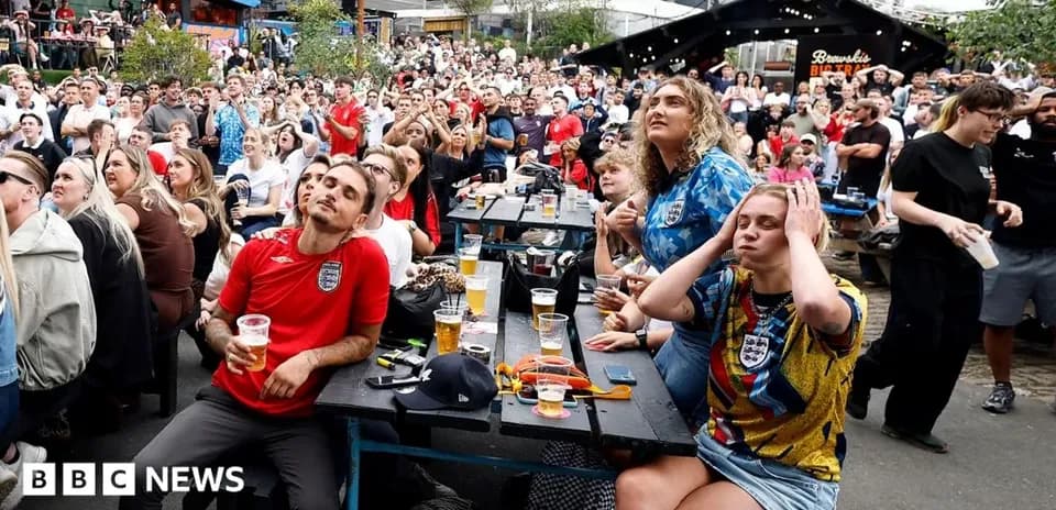 Fans watching a football match in a crowded venue
