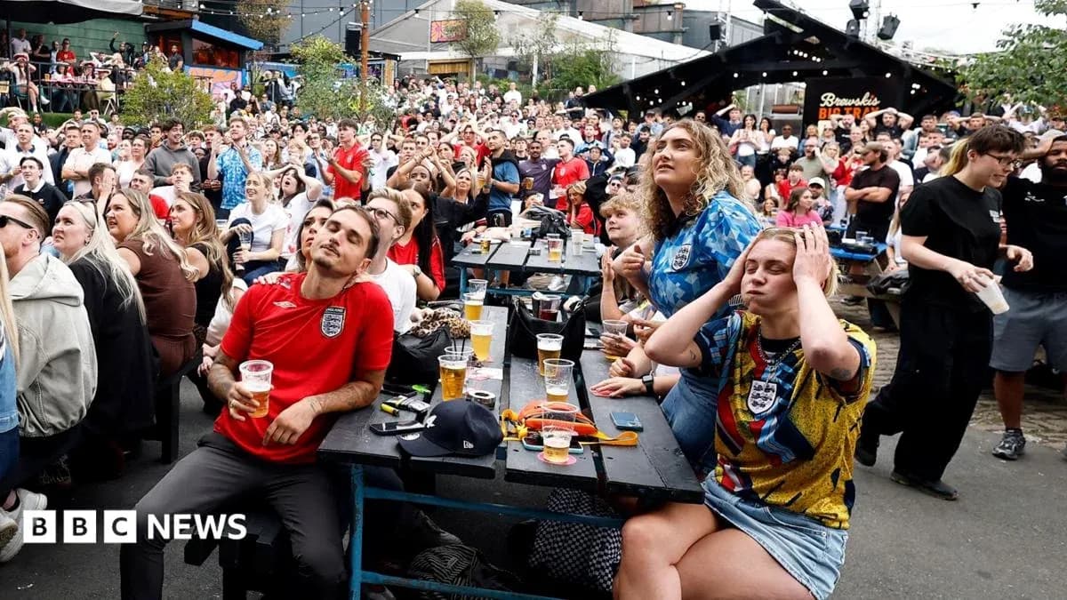 Fans watching a football match in a crowded venue