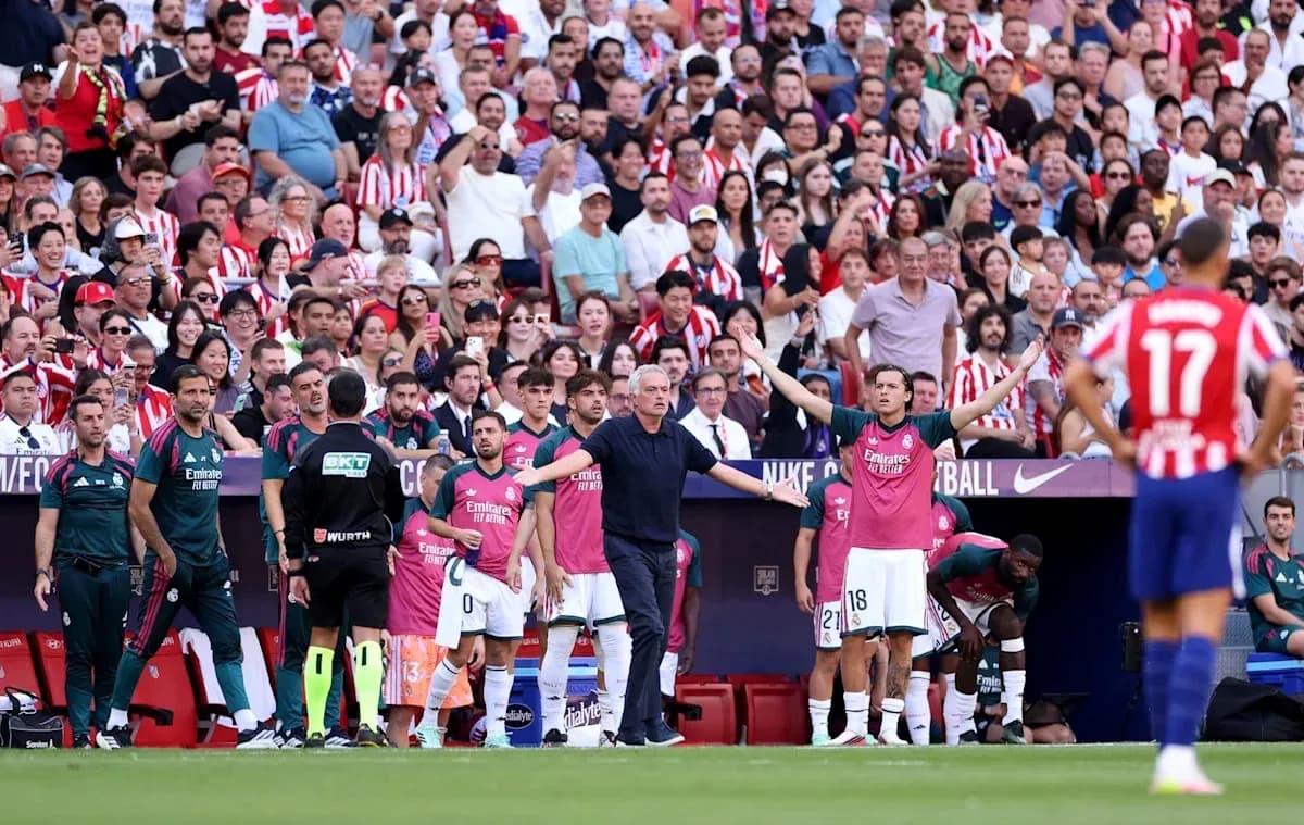 Coaching staff and players on sidelines during match