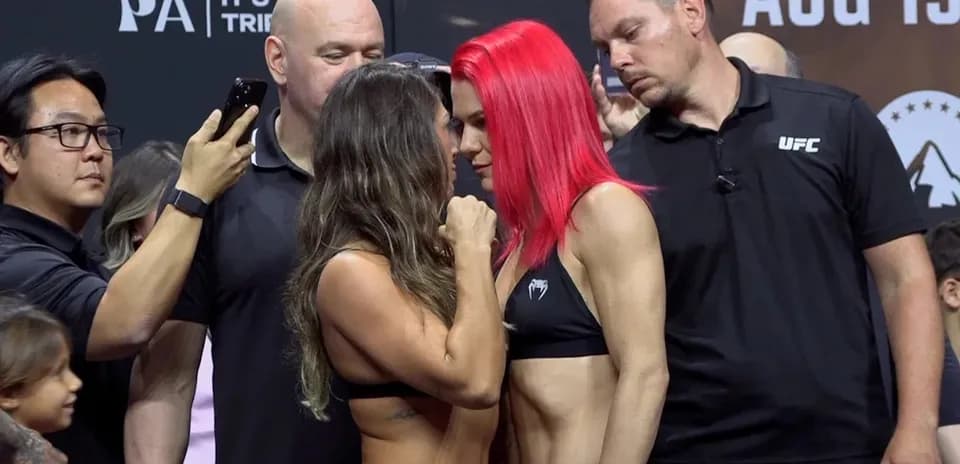 Two fighters facing each other during weigh-in event