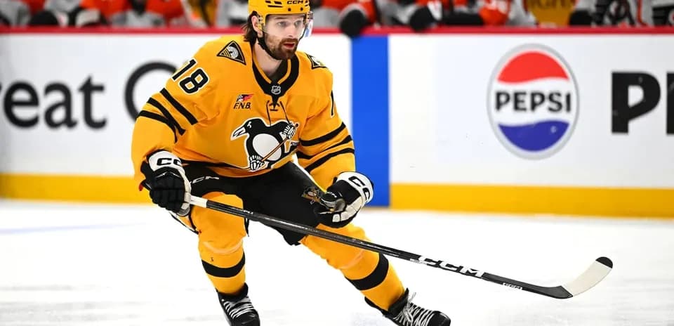 Hockey player skating with puck during match