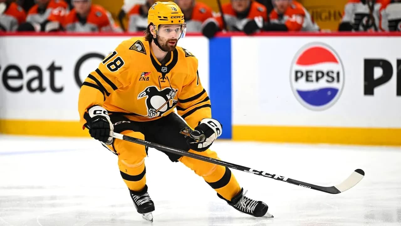 Hockey player skating with puck during match