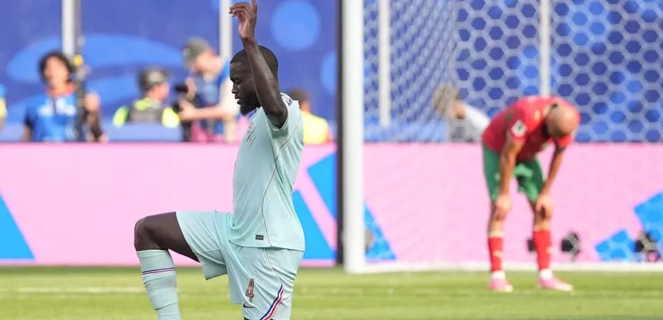 Defender kneeling on pitch during match action
