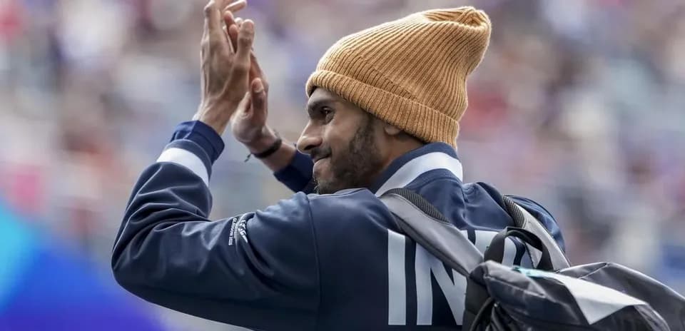 Sportsperson waving while wearing a beanie