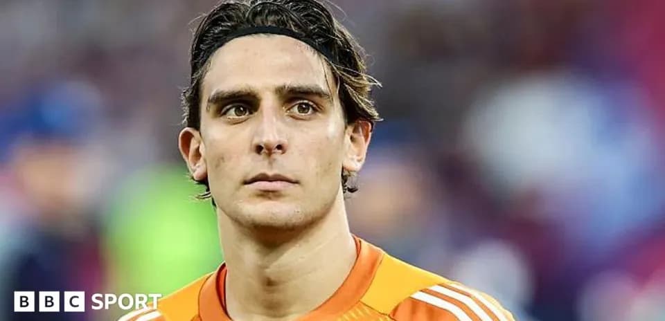 Goalkeeper in orange jersey looking focused
