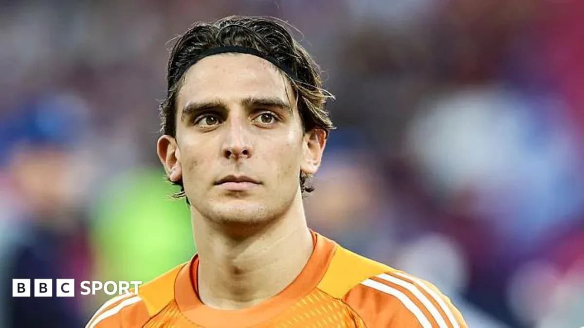 Goalkeeper in orange jersey looking focused