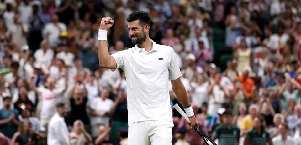 Tennis player celebrating in front of cheering crowd