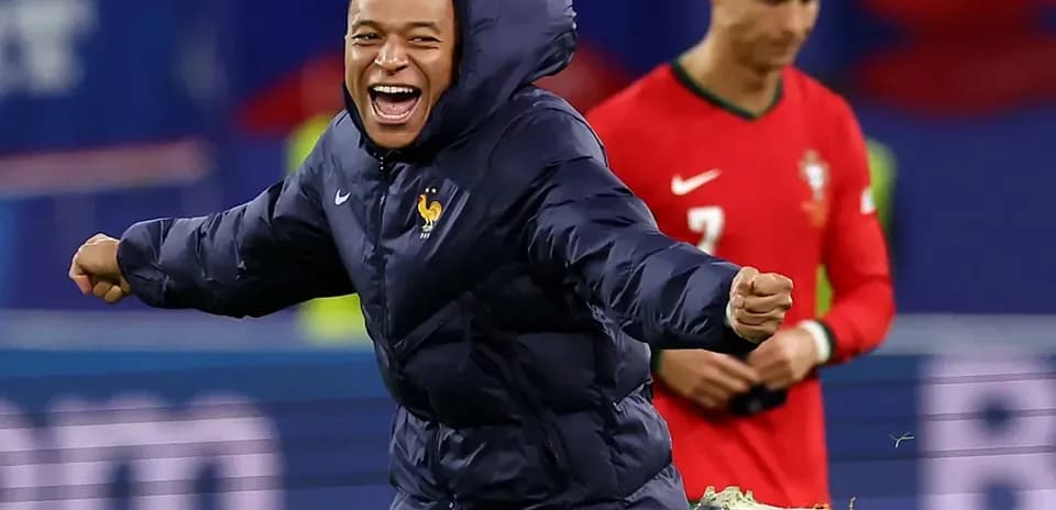 Mbappé celebrating in France jacket during match