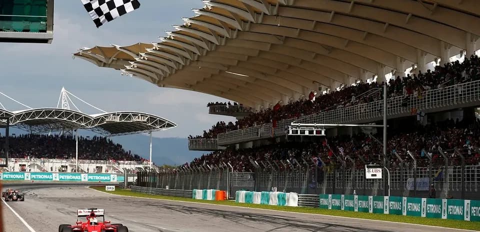 Formula 1 car crossing finish line with checkered flag