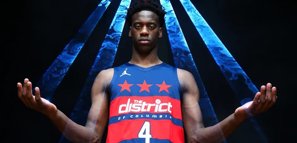 Basketball player posing in jersey with raised arms
