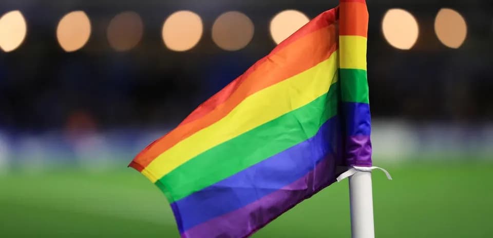 Rainbow flag at the corner of a football pitch