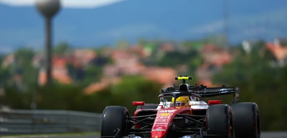 Formula 1 car racing on track with background scenery