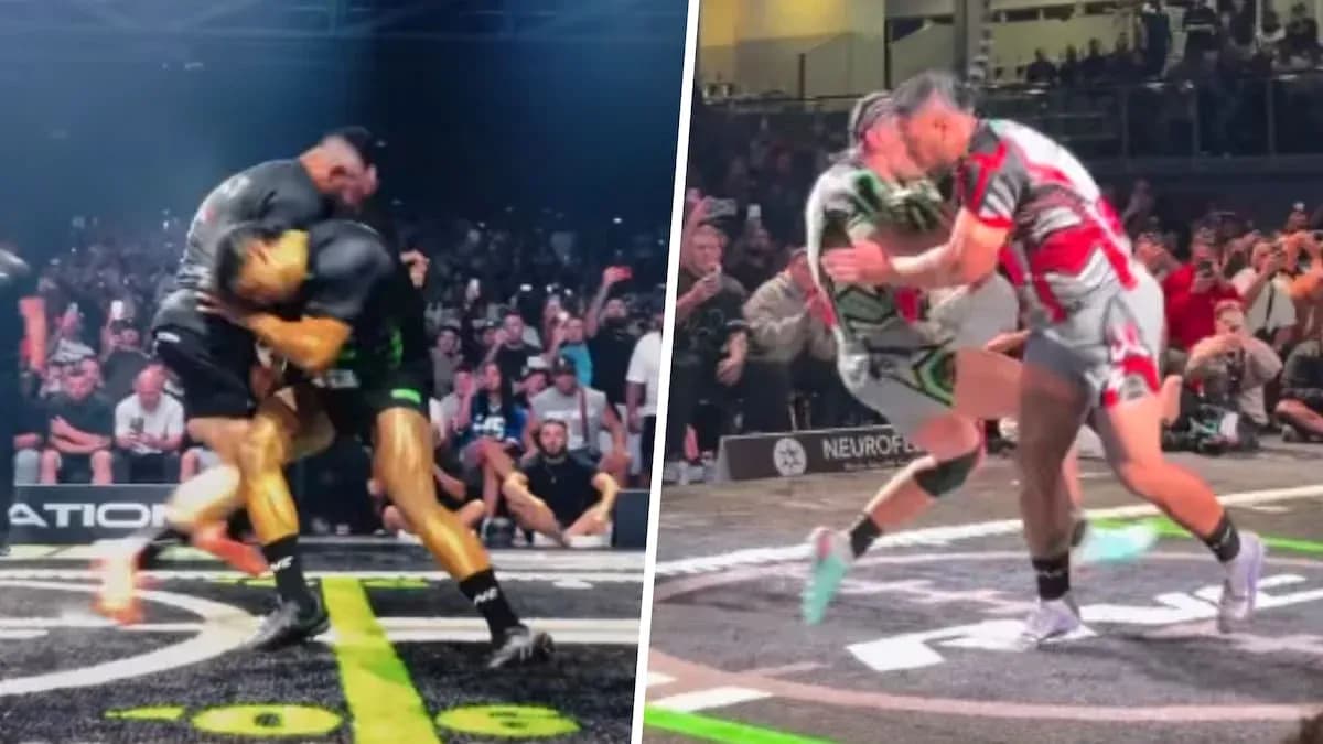 Two wrestlers competing in a match with audience Two wrestlers competing in a match with audience