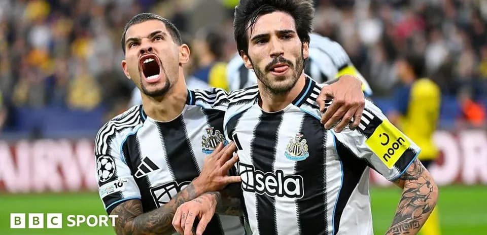 Newcastle players celebrating a goal on the field